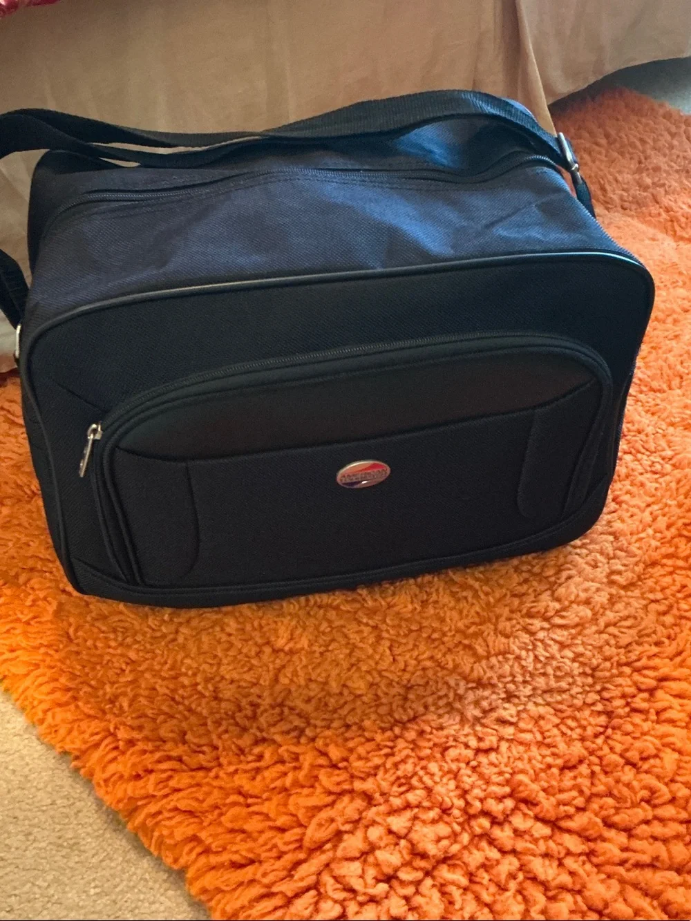 American Tourister Black Travel Duffel Bag - Front Pocket, Back Attachment.